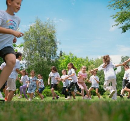 a group of young people playing a game of frisbee