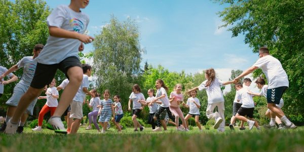 a group of young people playing a game of frisbee