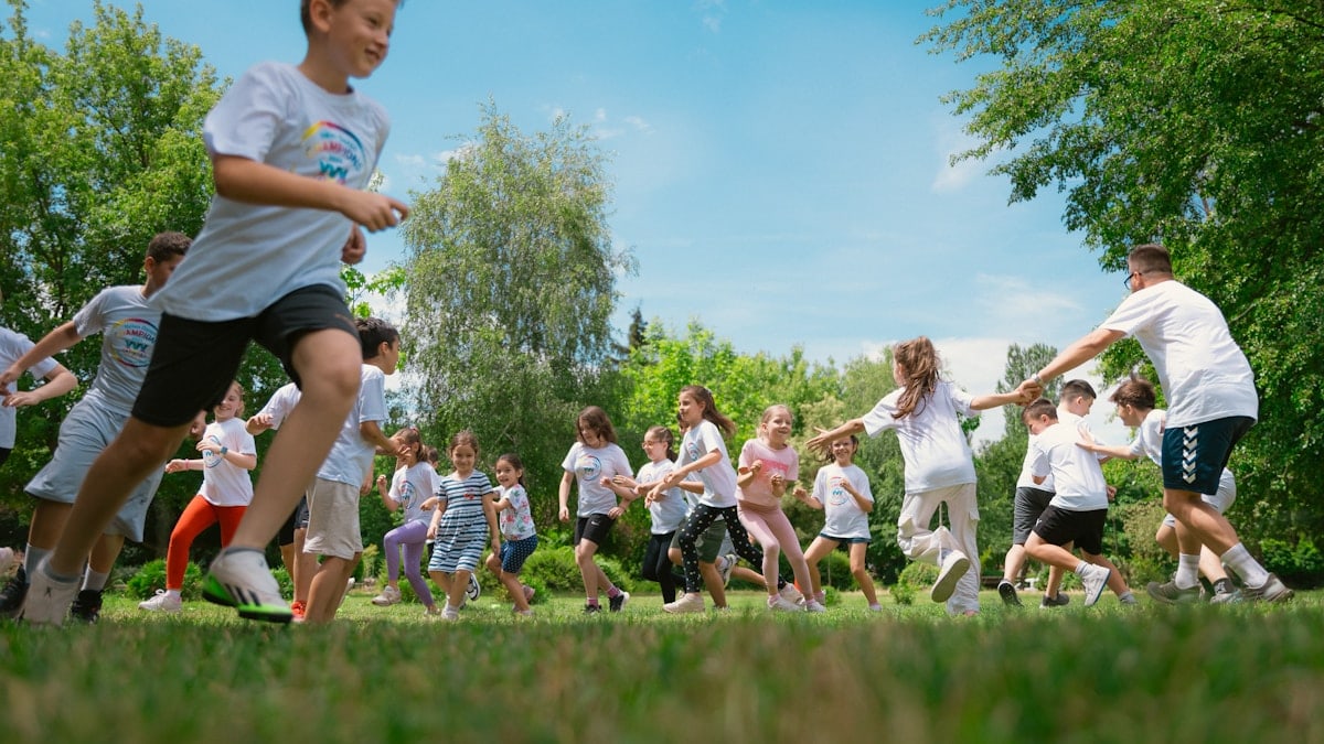 a group of young people playing a game of frisbee